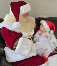 Santa Paul and Little Girl during a Home Visit