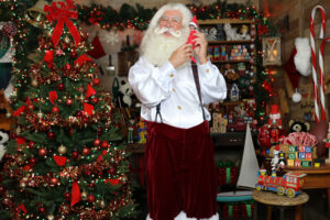 Santa Paul getting an update from an Elf on the Shelf